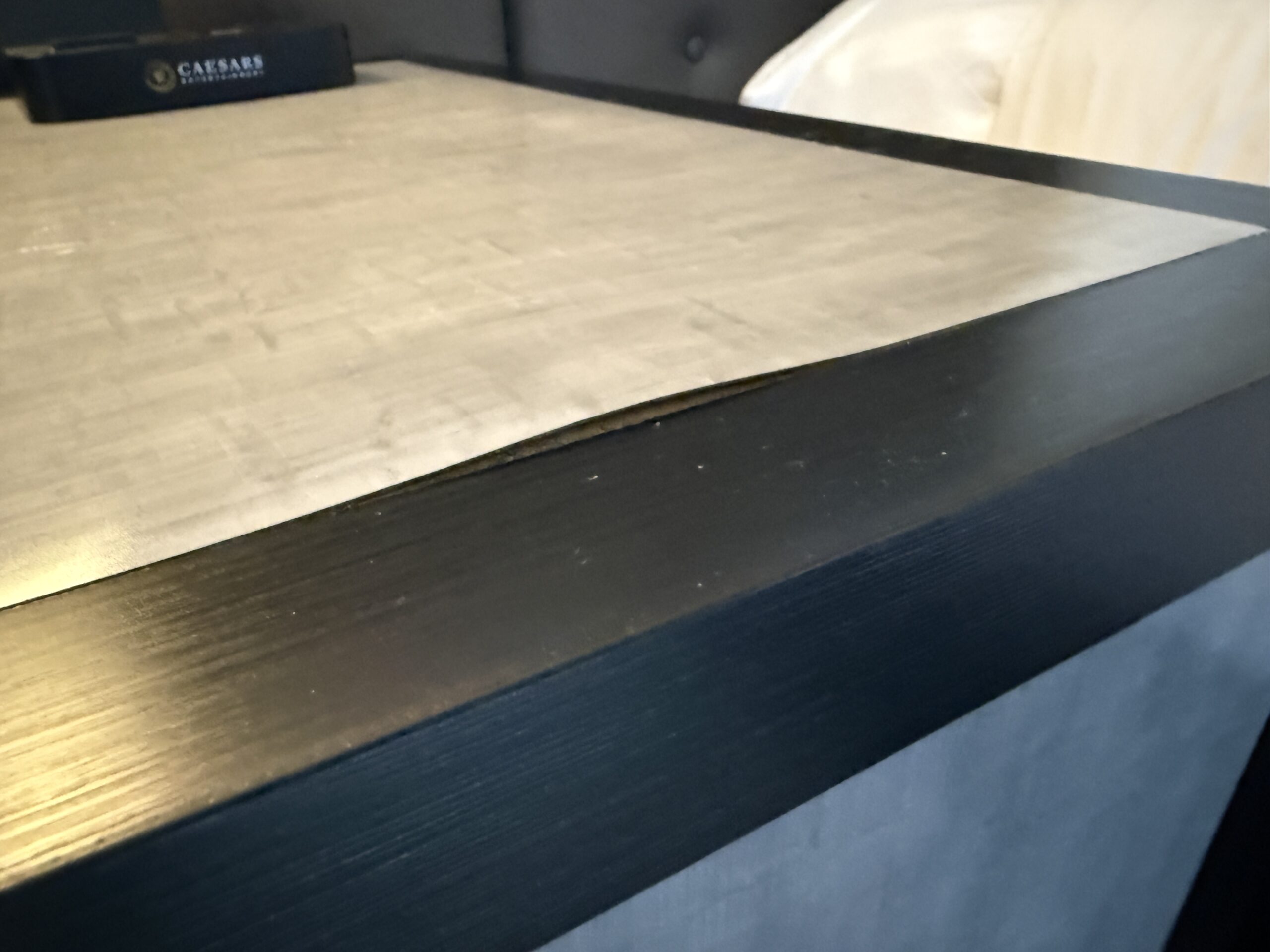 Peeling laminate top of the table.